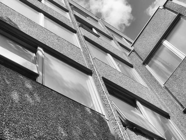 istock angled corner perspective view of a modern concrete office building looking upwards with clouds and sky 1064630474