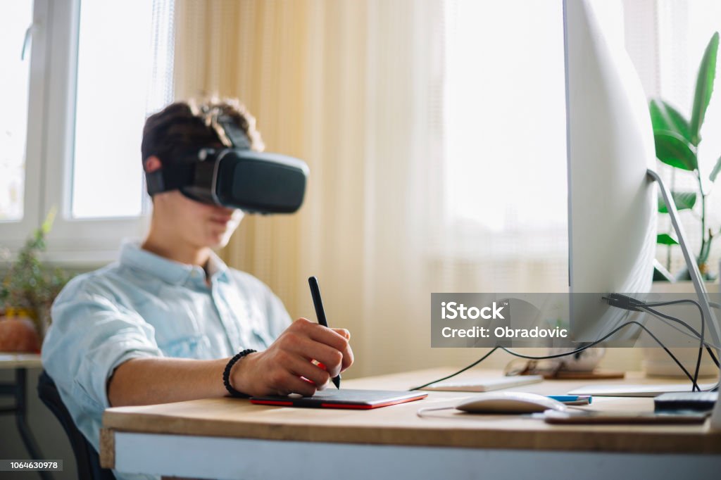 In A Computer Science Class Boy Wearing Virtual Reality Headset Works ...