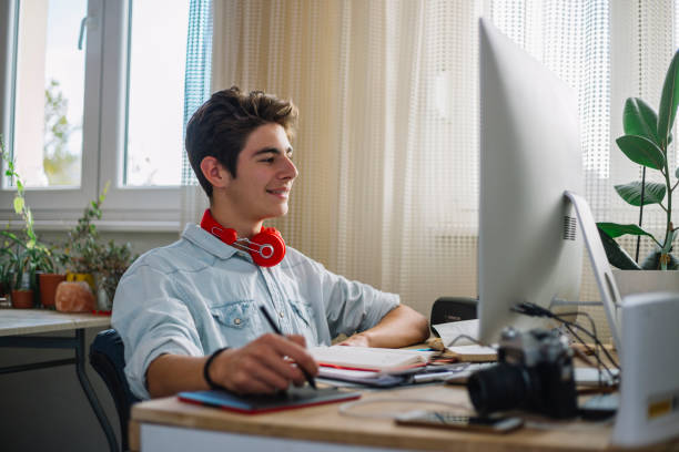 istock Young teenage boy  - graphic designer at work 1064631552