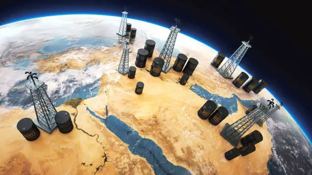 Photo of World globe Middle east, with oil barrels and drilling towers
