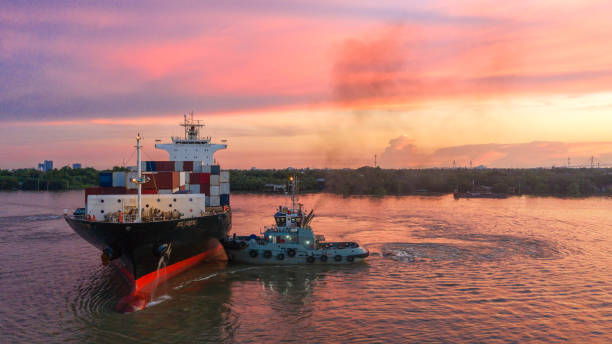 istock Container ship in export and import business and logistics. Shipping cargo to harbor by crane. Water transport International. Aerial view and top view. 1064635196