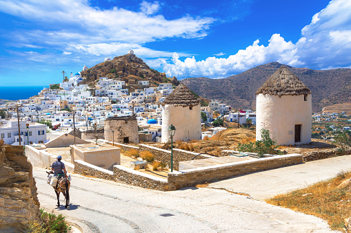 Traditional houses, wind mills, churches  and donkey in Ios island, Cyclades, Greece.