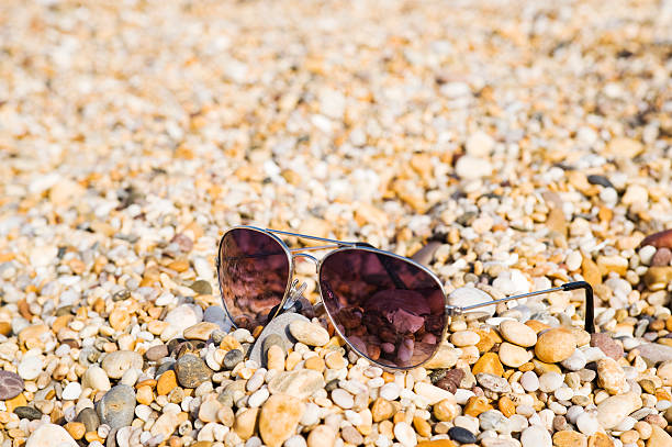 Pair Of Sunglasses Lying On The Beach stock photo