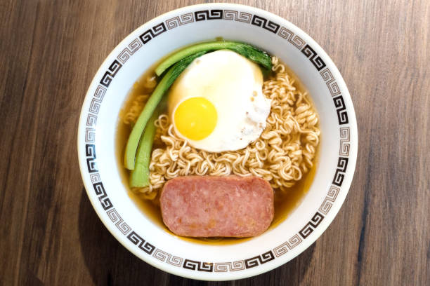 istock Hong Kong breakfast, sunny side up fried egg and luncheon meat on instant noodle 1064647044