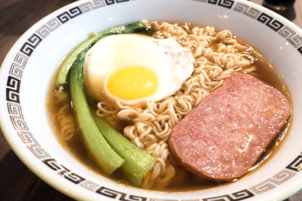 istock Hong Kong breakfast, sunny side up fried egg and luncheon meat on instant noodle 1064647380