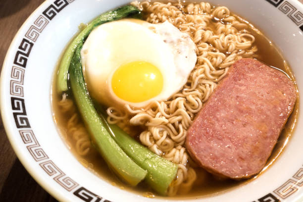 istock Hong Kong breakfast, sunny side up fried egg and luncheon meat on instant noodle 1064649604