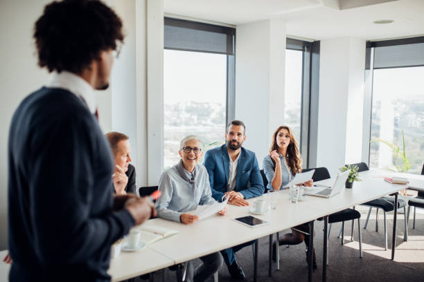 istock Businessman looking at his coworkers 1064651380