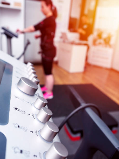 Close up of EMS with woman in electro muscular stimulation suit training stock photo