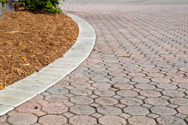 istock curved low angle brick paver driveway with mulch pile 1064655726