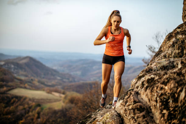 istock Young woman running on mountain 1064656798