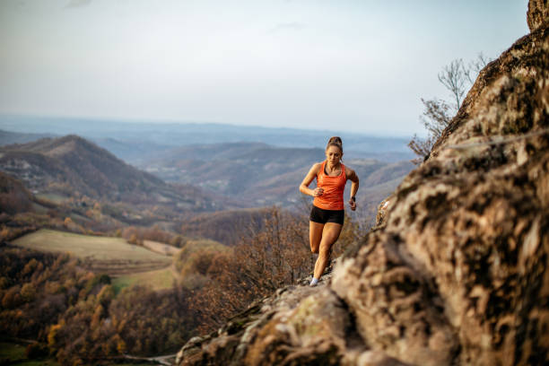 istock Young woman running on mountain 1064656800