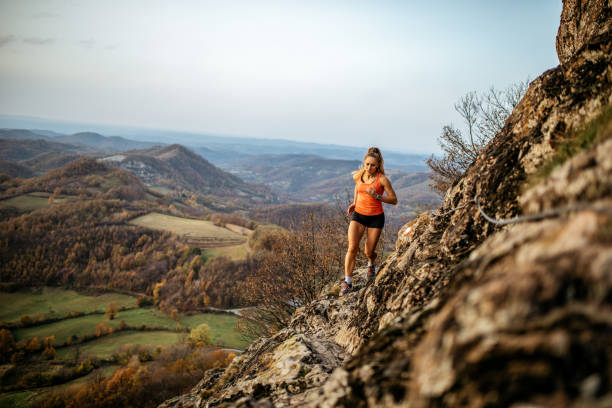 istock Young woman running on mountain 1064658014