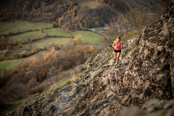 istock Young woman running on mountain 1064658150