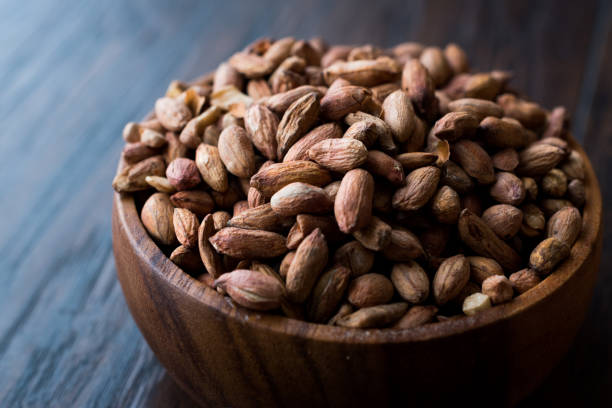 istock Organic Pistachio Nuts Without Shell in Wooden Bowl. 1064658328