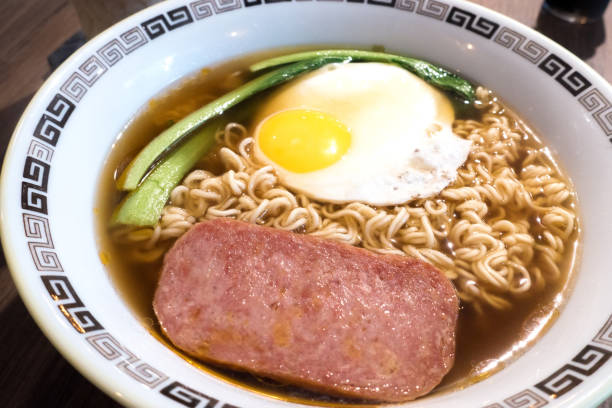 istock Hong Kong breakfast, sunny side up fried egg and luncheon meat on instant noodle 1064661518