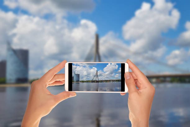 istock Tourist makes a photo of cable-stayed bridge in Riga 1064661638