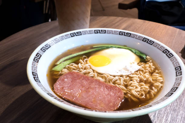 istock Hong Kong breakfast, sunny side up fried egg and luncheon meat on instant noodle 1064661686