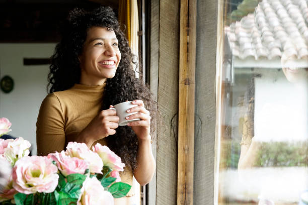 istock Woman drinking coffee, looking out the window 1064664700