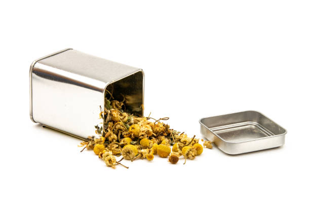 Isolated dried chamomile tea herbal infusion from a metal tin container Isolated dried chamomile tea herbal infusion from a metal tin container decaffeinated stock pictures, royalty-free photos & images