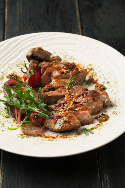istock Grilled pork steak with spices, rosemary and arugula 1064676396