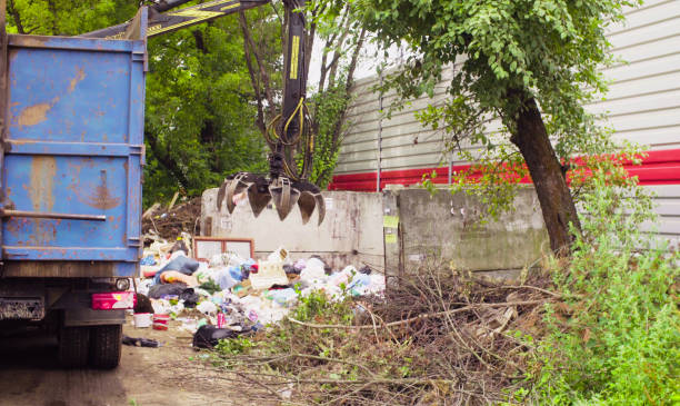istock Robotic arm of garbage truck taking gabbage 1064676538