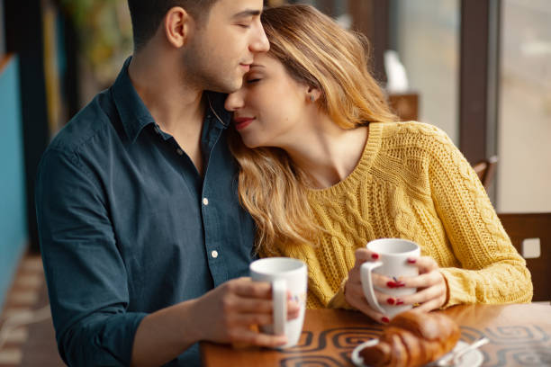 istock Young couple in love sitting in a cafe, drinking coffee 1064677806