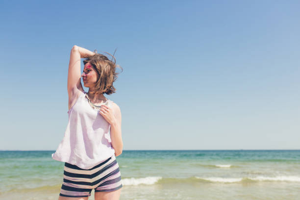 istock Woman with body paint on the beach 1064677856