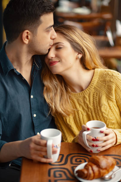 istock Young couple in love sitting in a cafe, drinking coffee 1064677862