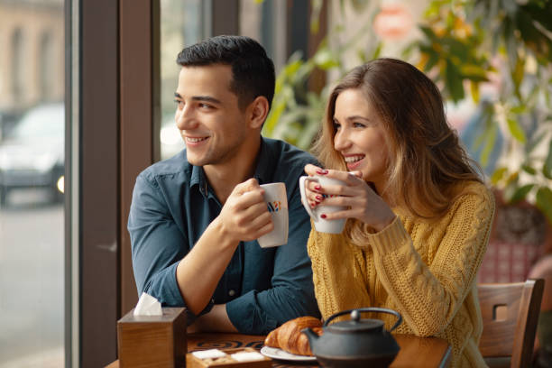 istock Young couple in love sitting in a cafe, drinking coffee 1064677920