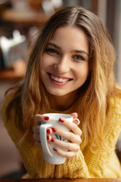 istock Young charming woman having coffee in a coffee shop 1064678980