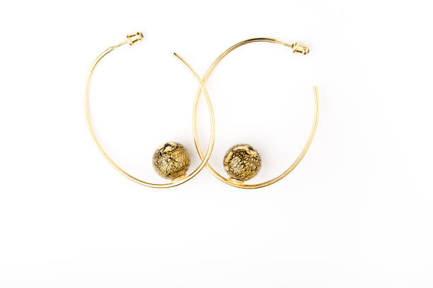 istock gold earrings stone white background 1064679024