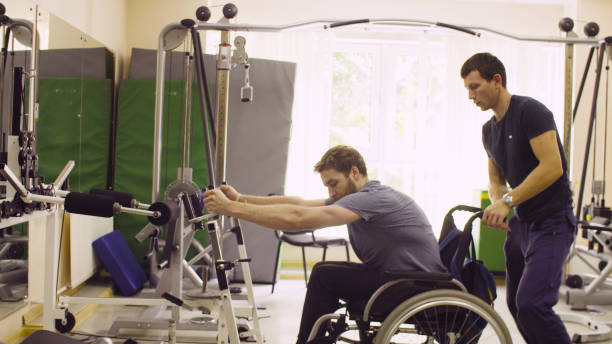istock Disabled man in wheelchair doing hand exercises 1064681664
