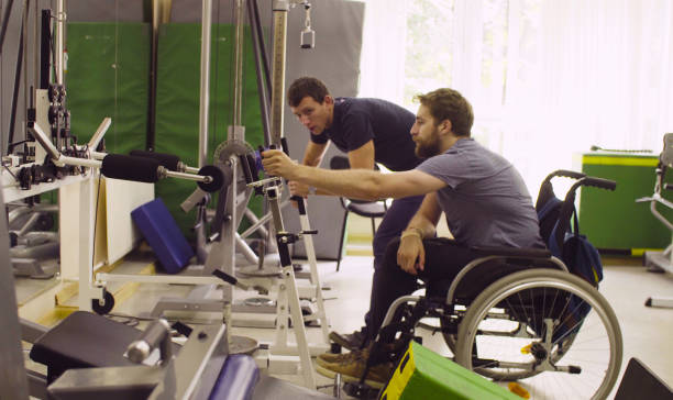 istock Disabled man in wheelchair doing hand exercises 1064681700