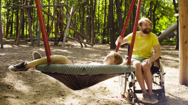 istock Woman is lying on a swing and a man is pushing a swing 1064683262