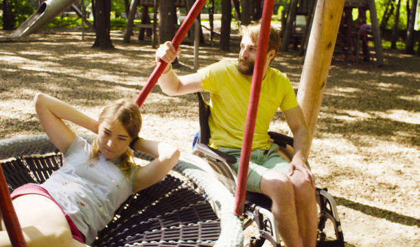 istock Woman is lying on a swing and a man is pushing a swing 1064683276