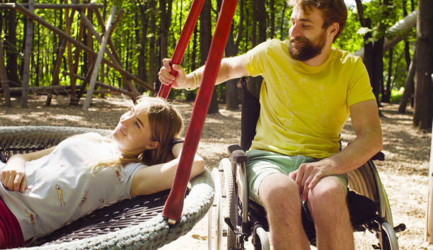 istock Woman is lying on a swing and a man is pushing a swing 1064683298
