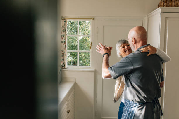 istock Senior couple dancing at home 1064683336