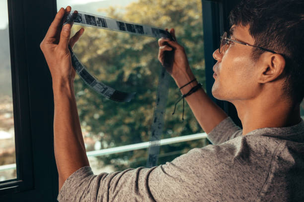 istock Photographer selecting a frame on old film 1064688356
