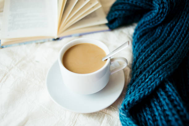 istock cup of tea with milk on a textile background with a knitted sweater and  needles 1064688510