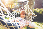 Young woman lying down and sleeping on a hammock