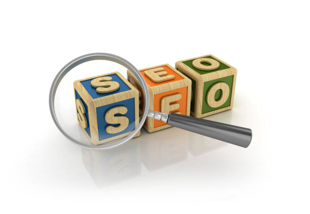 istock SEO Buzzword Cubes with Magnifying Glass - 3D Rendering 1064692320