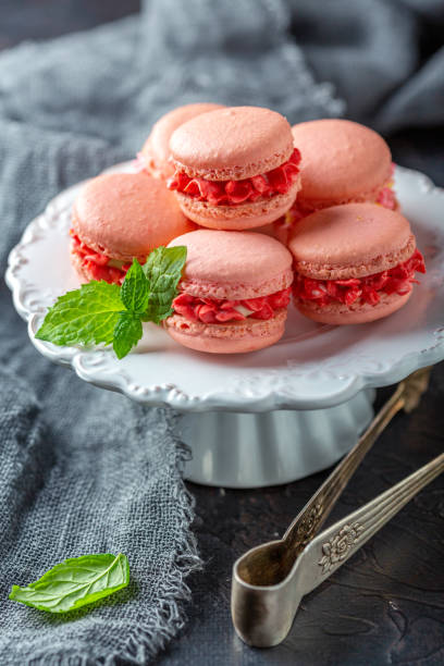 istock Almond cakes macarons with cream flowers. 1064693858