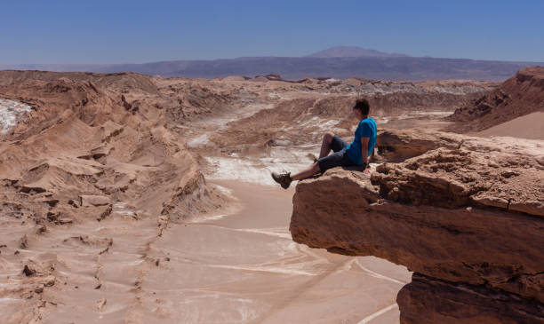 istock Hiker on a cliff in Atacama desert 1064695758