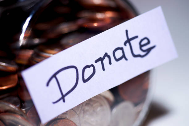 istock Jar of Coins with a Hand Printed Lable DONATE 1064699172