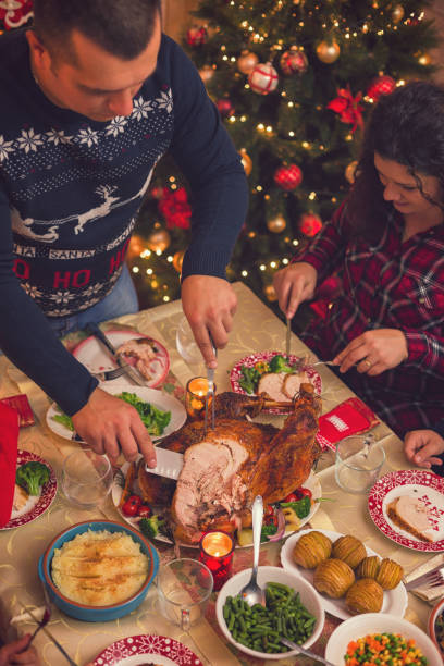 istock Young father carving stuffed roasted turkey for Christmas dinner 1064699736