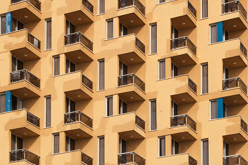 Yellow residential building with identical balconies