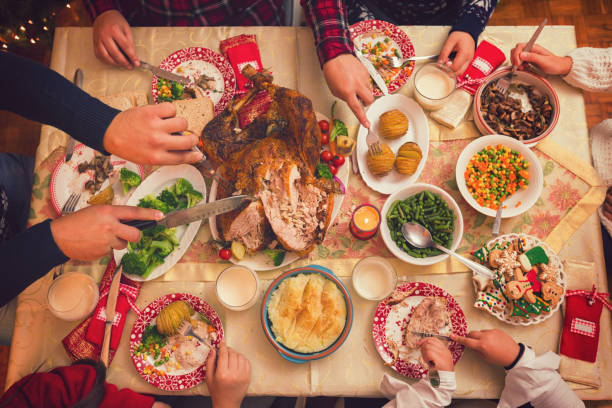 istock Young father carving stuffed roasted turkey for Christmas dinner 1064701612