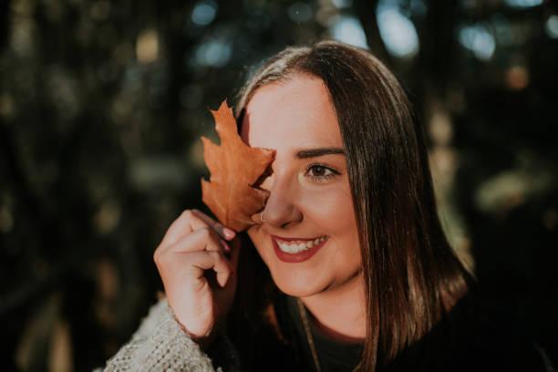 istock Young woman with autumn leaf 1064702706