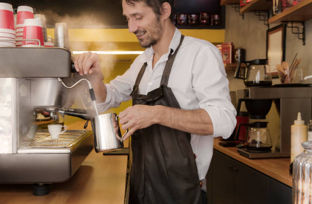 istock Barista making a cup of coffee in machine 1064703350