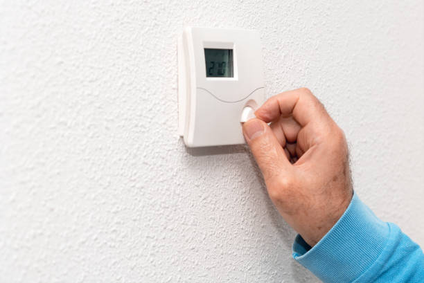 istock Man hand adjusting thermostat at home. Celsius temperature scale. 1064705184